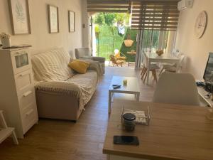 a living room with a couch and a table at BUNGALOW LA ISLA in Jávea