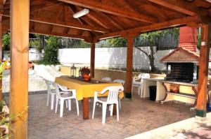 a patio with a table and chairs and a grill at EXOHI STUDIOS in Sarti +30 photos