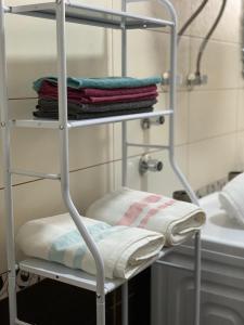 a towel rack with towels on it in a bathroom at Dream House Korça in Korçë +68 photos