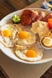 a plate of eggs and other food on a table at Apartments Horizont in Budva