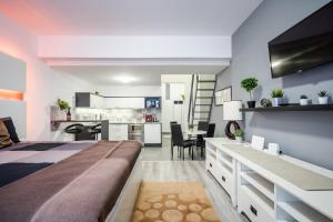 a bedroom with a large bed and a kitchen at BpR Elite Apartments - Sky Terrace in Budapest