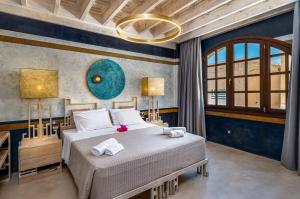 a bedroom with a bed and a large window at 10GR Boutique Hotel & Wine Bar in Rhodes Town