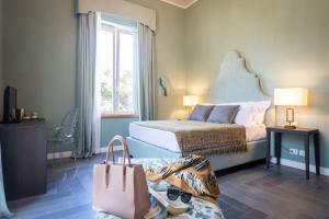 a hotel room with a bed and a large window at Villa Masetta - Luxury Suites in Mondello