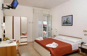 Postel nebo postele na pokoji v ubytování Hotel Ciondolo D'Oro