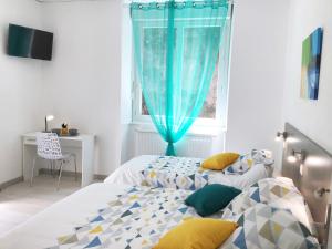 a bedroom with two beds and a window at Appartement Le Solea 100m2 climatisé parking proche Sanctuaires in Lourdes
