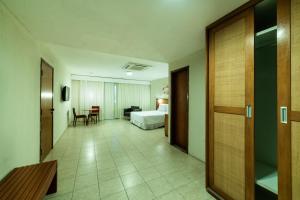 a hotel room with a bed and a table and chairs at Hotel Praia Centro in Fortaleza +86 photos
