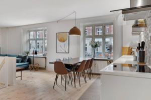 a kitchen and dining room with a table and chairs at Stylish two floor apartment in vibrant Nørrebro in Copenhagen