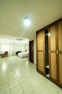 a hotel room with a bed and a bedroom at Hotel Praia Centro in Fortaleza