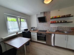 a kitchen with a sink and a stove top oven at Ferienwohnung Sonnenschein in Sagard