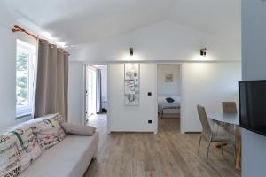 a living room with a couch and a table at Apartments Elizabeta 1701 in Fažana