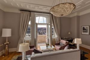 a living room filled with furniture and a window at Four Seasons Hotel Gresham Palace Budapest in Budapest