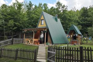 a tiny house with a green roof at Honeywood Cabin II with Private Spa in Bijelo Polje
