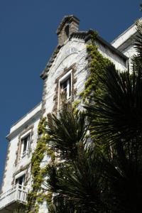 a building with a tower with a clock on it at Hôtel Des Deux Mers in Saint-Pierre-Quiberon