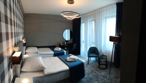 Łóżko lub łóżka w pokoju w obiekcie Hotel Sanova
