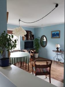 a living room with a table and chairs and a living room at Bajka in Gdańsk