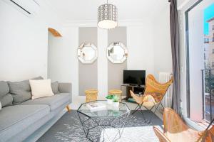 a living room with a couch and a table at Genteel Home Chueca in Madrid