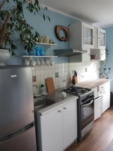 a kitchen with a sink and a stove top oven at Bajka in Gdańsk