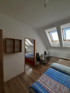 a bedroom with two beds and a table with a mirror at Penzion Fontána in Mikulov