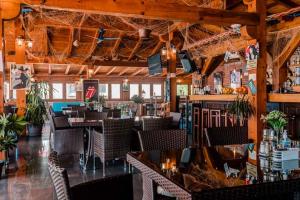 a restaurant with tables and chairs and a bar at Apartments Horizont in Budva