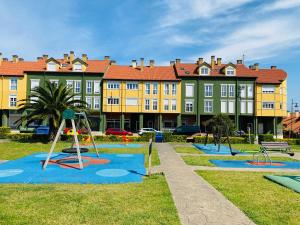 a group of playground equipment in front of a building at NEXT STOP PLAYA SALINAS in Salinas