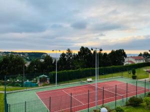 a tennis court with a net on top of it at NEXT STOP PLAYA SALINAS in Salinas