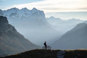 a person riding a bike on top of a mountain at Hotel Central in Engelberg
