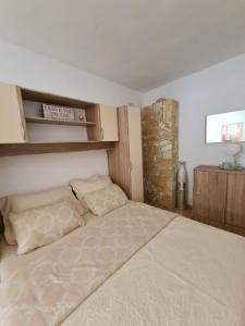 a bedroom with a large bed with two pillows at Apartments Simona in Ražanj