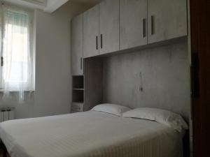Schlafzimmer mit einem großen weißen Bett und weißen Schränken in der Unterkunft Mare Blu CITRA 011017-LT-0579 in Levanto