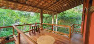 a porch of a house with a table and chairs at Pousada Tatu do Bem in Lençóis