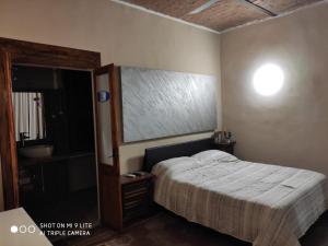 a bedroom with a bed and a large mirror at ZED-HOUSE in Nizza Monferrato