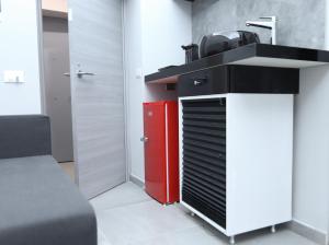 a kitchen with a red refrigerator and a red cabinet at Montesanto Station in Naples