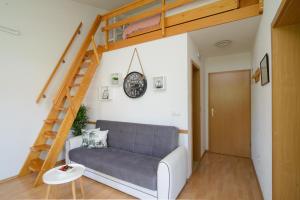 a living room with a couch and a loft bed at Apartments Kasalo in Trogir