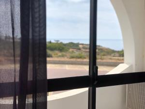an open window with a view of a street at Apartamento em cima da praia - Carvoeiro - Algarve in Poço Partido