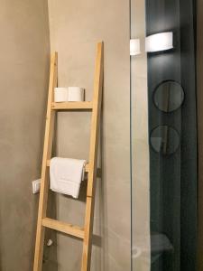 a bathroom with a ladder and a shelf with towels at F.T.P Luxury Rooms in Patra +29 photos