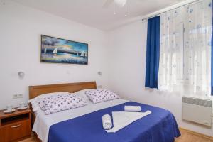 Postel nebo postele na pokoji v ubytování Apartments Kasalo