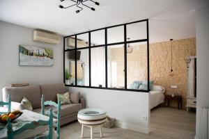 a living room with a couch and a large window at Apartamentos Rincón de Cantarranas in Alhama de Aragón