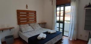 a bedroom with a bed with two towels on it at Pretty house close to metro and wine cellars - host 8 in Vila Nova de Gaia