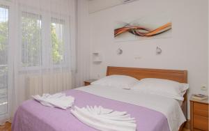 Postel nebo postele na pokoji v ubytování Apartments Kasalo