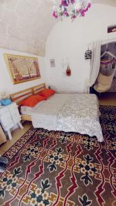 a bedroom with a bed and a rug at La Casa Di Lo in Monopoli