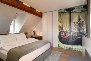 a bedroom with a large painting on the wall at Zlata Ladjica Boutique Hotel in Ljubljana