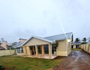 a house with a driveway in front of it at 36 frere road shelly beach , margate in Margate