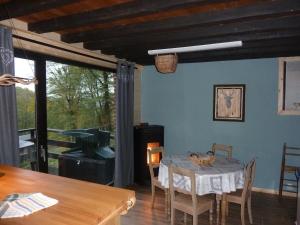 a dining room with a table and chairs and a window at Le refuge in Hastière-par-delà