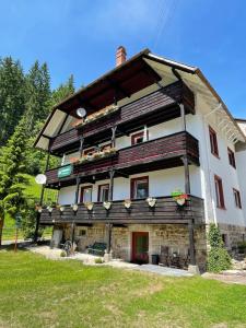 a large building with flowers on the front of it at Waldblick Ferienwohnungen in Bonndorf im Schwarzwald