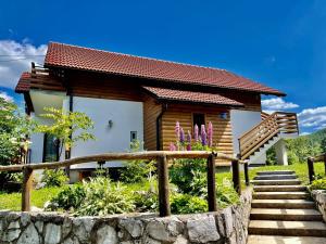 a small house with a staircase in front of it at Studio Apartmani Patricia in Smoljanac