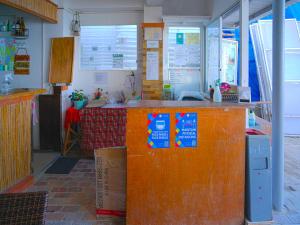 a kitchen with a counter with signs on it at Niu Ohana East Bay Apartments in Boracay