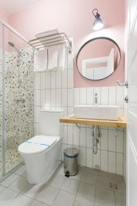 a bathroom with a toilet and a sink and a mirror at Partner Guest House Velyka Vasylkivska in Kyiv +66 photos