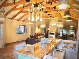 a large living room with a large table in the middle at Drakensberg Inkosana Lodge in Champagne Valley