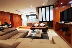 a living room with a couch and a tv at 1507-Amazing views & Unique Joburg CBD Luxury in Johannesburg