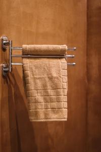 a towel hanging on a towel rack in a bathroom at Alto Suite (Cielo suites) in Kavala