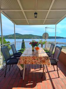 a table and chairs on a patio with a view of the water at Apartment Angelina in Dubrovnik